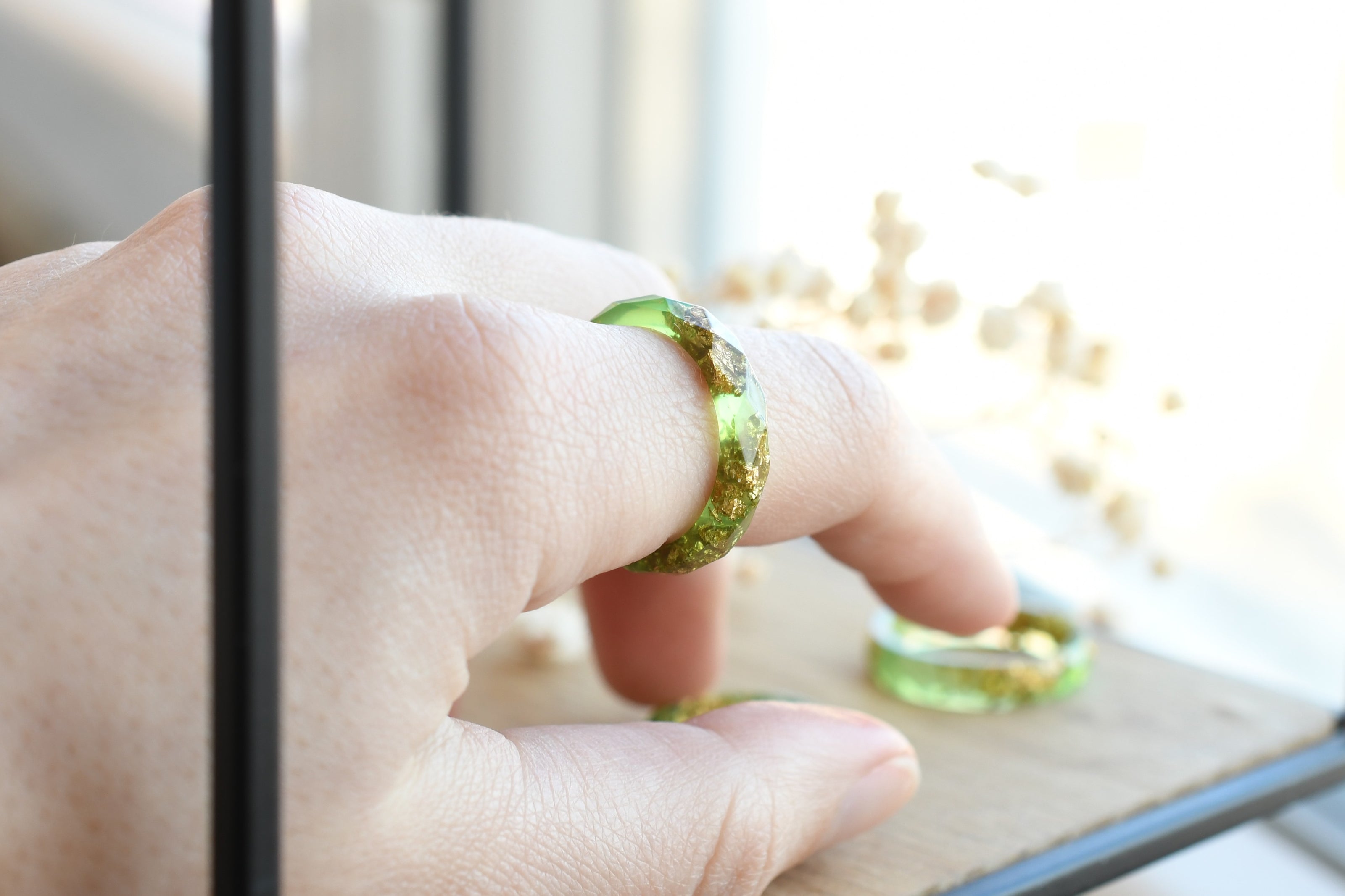Light green resin ring worn on hand — unisex minimalist jewelry