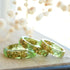 Light green resin ring with gold flakes handmade by Resity in Vienna