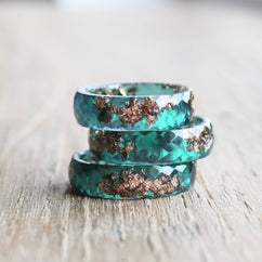 Minimalist jade ring styled with floral background