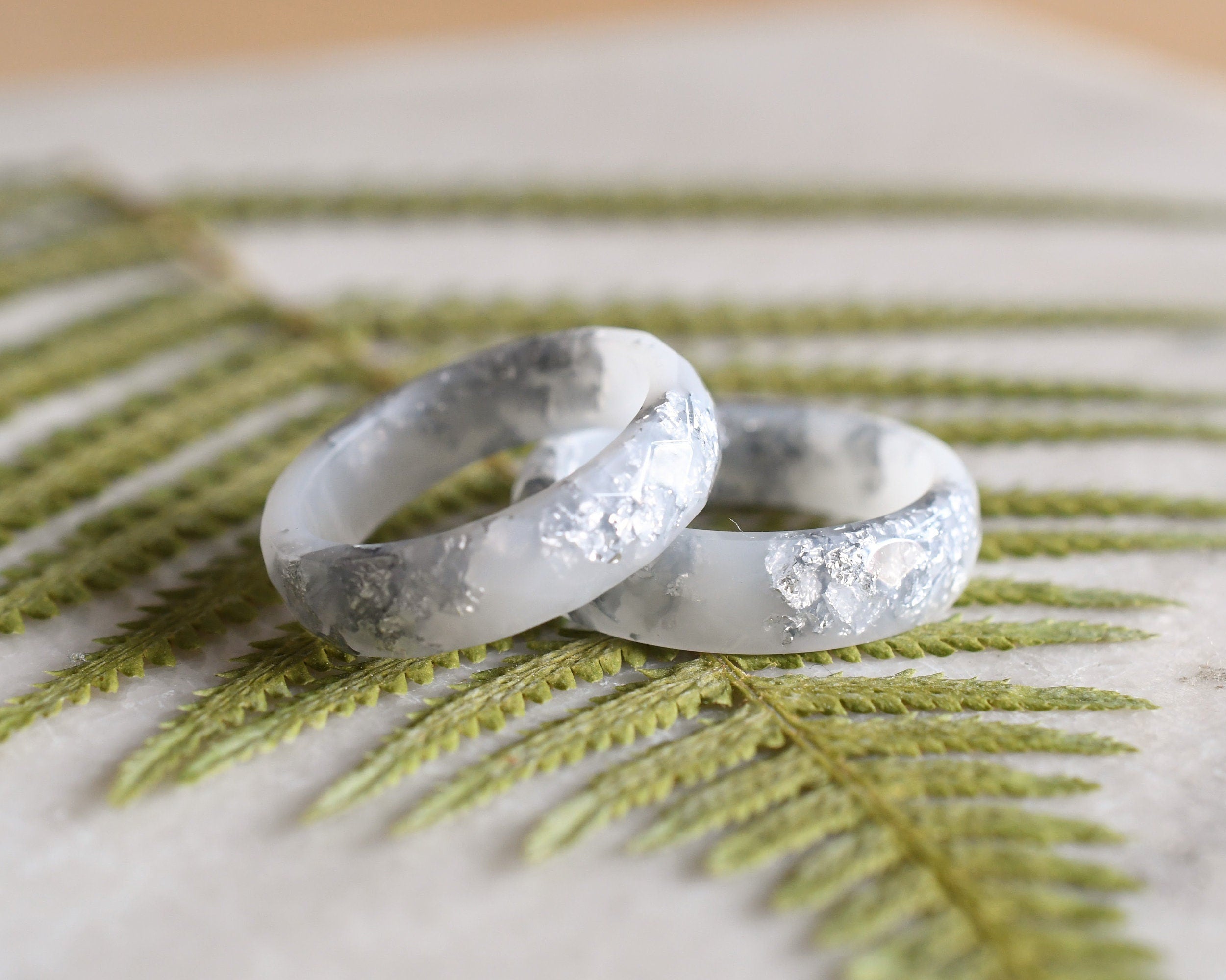Smooth white resin ring with shimmering silver flakes — minimalist handmade jewelry